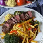 Beef Strips with Colorful Veggie Sauté and Golden Fries