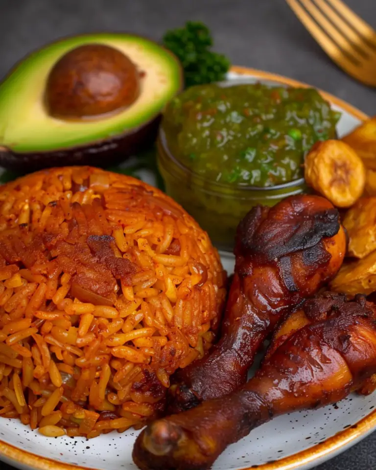 Jollof Rice with Grilled Chicken, Fried Plantains, Green Vegetable Sauce, and Avocado