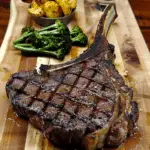 Smoked Tomahawk Steak Board with Spicy Loaded Baked Potatoes & Broccolini