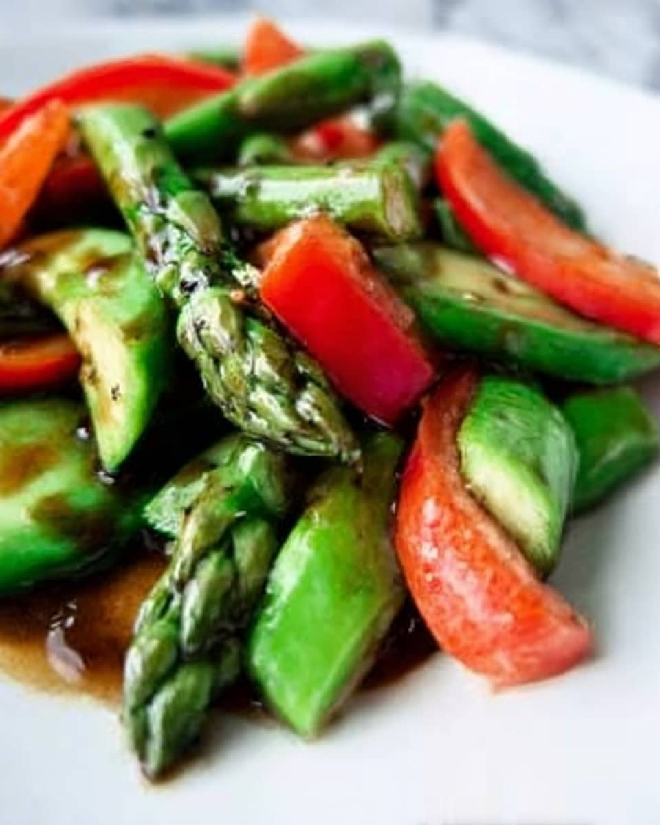 A close-up of a white plate filled with cut green asparagus pieces mixed with thick slices of red bell pepper. The asparagus is bright green with a crisp texture, some pieces showing slight brown seasoning. The red bell peppers add a splash of vibrant color, contrasting with the green. A shiny, dark sauce is drizzled over the vegetables, giving them a glossy look. The background is a white marbled texture. photo taken with an iphone --ar 4:5 --v 7