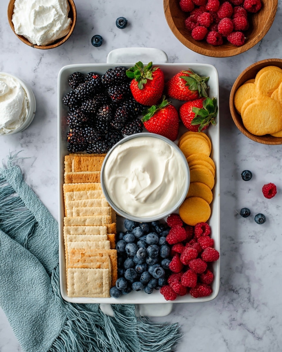 A white rectangular tray holds a bowl of smooth white creamy dip in the center. Around the bowl, there are layers of fresh blackberries on the top left, fresh red strawberries with green leaves on the top right, golden round crackers below the strawberries, fresh blueberries on the bottom right, bright red raspberries on the bottom left, and rectangular light brown crackers stacked on the left side. The tray is placed on a white marbled surface with additional bowls of whipped cream at the top left and raspberries and golden round cookies in wooden bowls on the right side. A light blue textured cloth with fringes is at the bottom left corner. Photo taken with an iphone --ar 4:5 --v 7