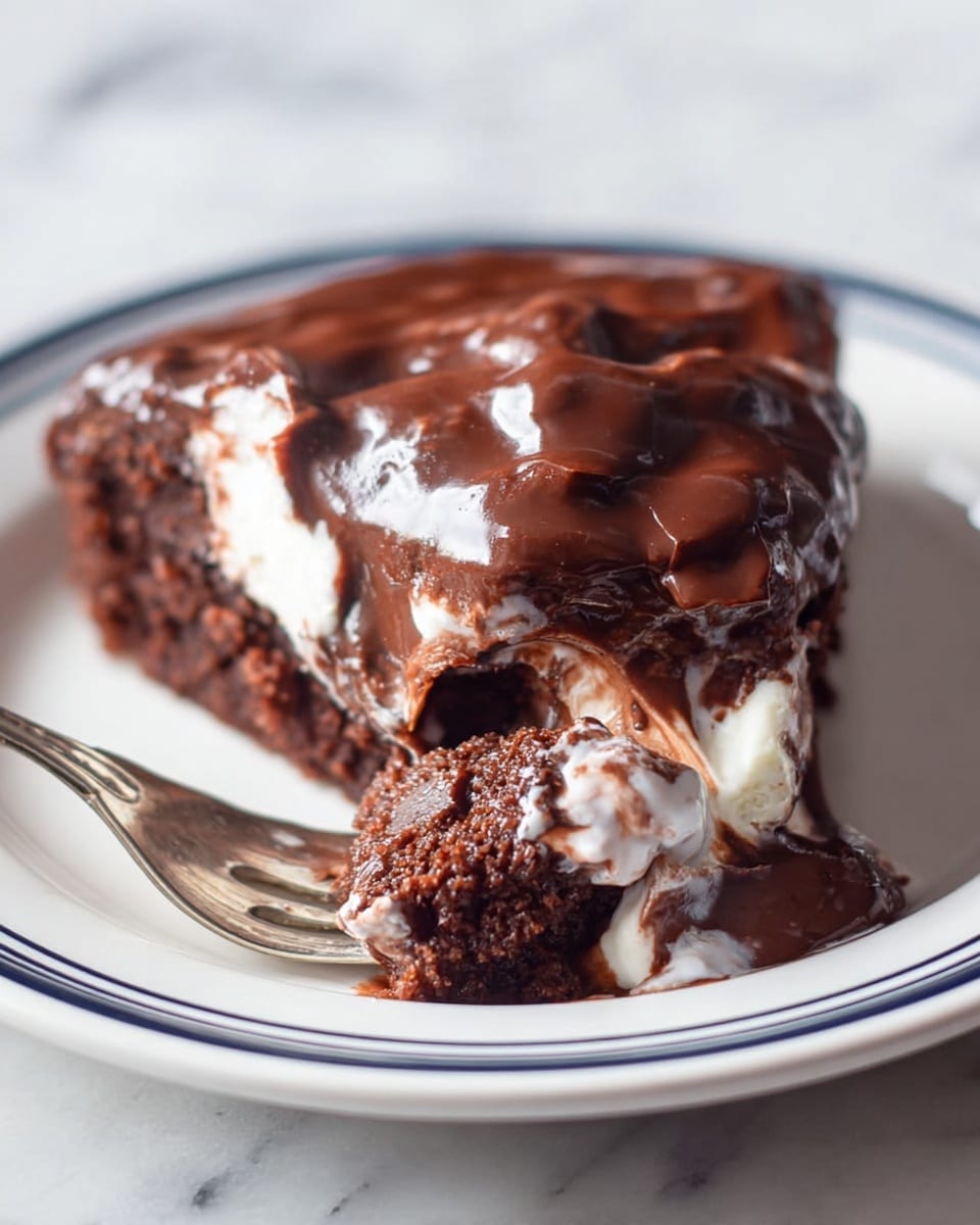 A single slice of chocolate cake with a glossy, thick chocolate layer on top, slightly melting and mixed with white cream patches. The cake layer is dark brown and moist with a soft texture. The slice sits on a white plate with thin dark blue rings near the edge. A fork holds a piece of the cake covered in melting chocolate and cream close to the camera, showing the rich inside. The background is a white marbled texture. photo taken with an iphone --ar 4:5 --v 7
