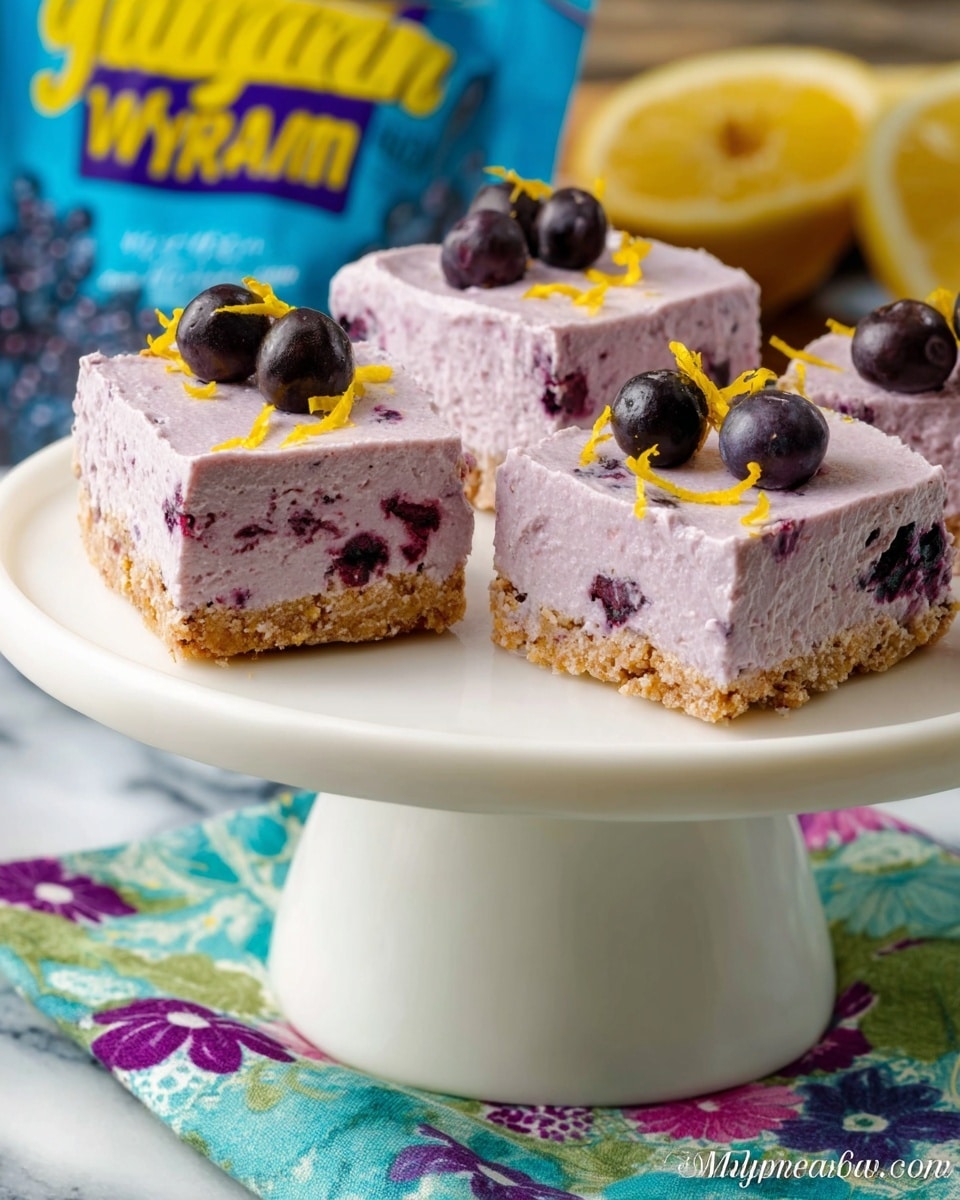 The image shows three square pieces of a purple berry cheesecake on a white cake stand against a white marbled texture background. Each piece has two layers: a light tan crumbly base and a thick, creamy, light purple top layer with visible dark purple berry spots inside. Each piece is topped with three small dark berries and scattered yellow zest. The cake stand is placed on a colorful cloth with blue, green, and purple flower patterns. A blue bag of mixed wild berries with a bright yellow resealable top is in the background. photo taken with an iphone --ar 4:5 --v 7