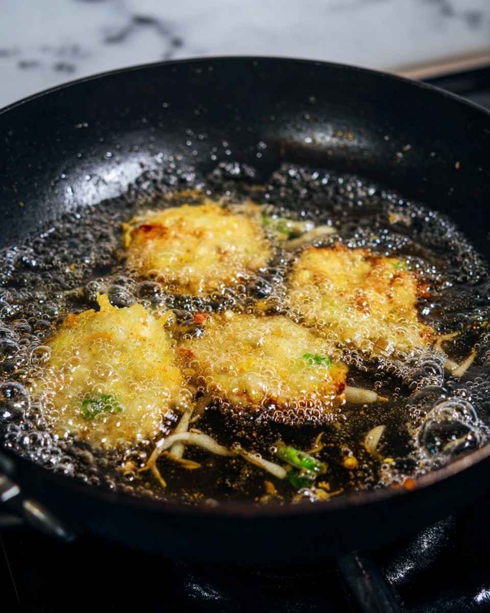 A golden-brown fried fritter with a rough and crispy texture sits in a round metal skimmer with a brown wooden handle. The skimmer is held over a black frying pan filled with bubbling oil. A silver spatula presses lightly on the fritter, highlighting its crunchy edges and uneven surface. The background shows a dark stove area with a slightly blurred look. photo taken with an iphone --ar 4:5 --v 7