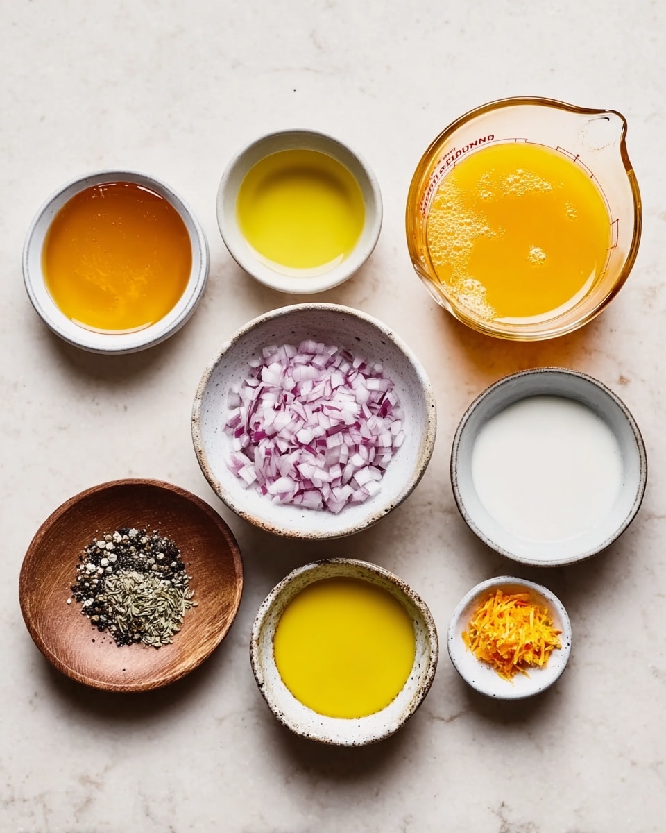 A clear glass bowl filled with a yellow liquid dressing that contains small white and purple chopped pieces evenly spread throughout. The dressing has tiny black specks on the surface, showing seasoning. A metal spoon with a worn handle rests inside the bowl. The bowl is placed on a white marbled surface. Photo taken with an iphone --ar 4:5 --v 7