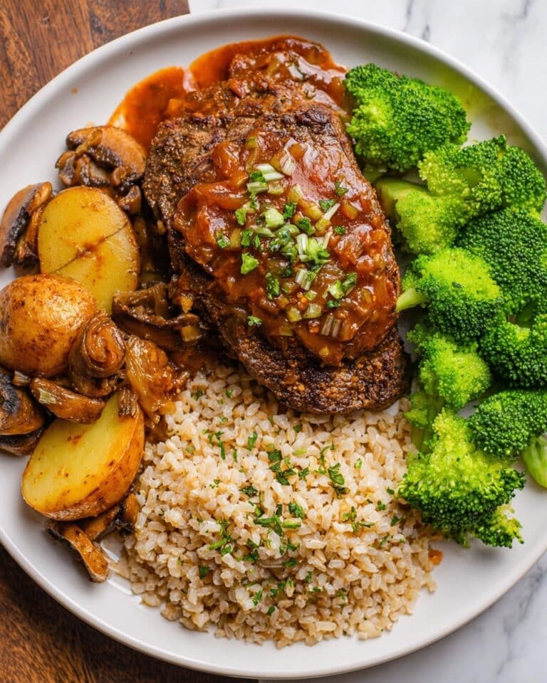 Tender Oven-Baked Round Steak with Potatoes, Mushrooms, and Tomatoes in a Savory Soy-Gravy Recipe