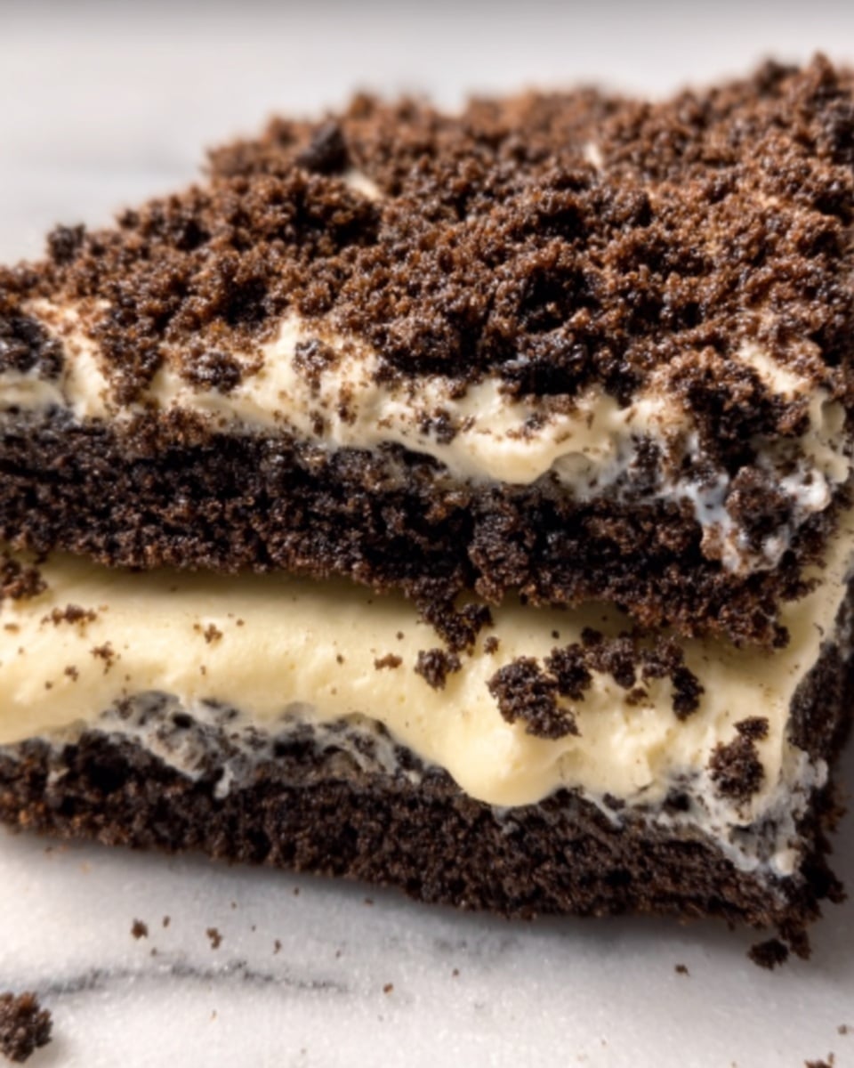 The image shows a close-up of a sandwich with two dark brown, crumbly cookie layers acting as the bread. Between the layers is a thick, creamy white filling with a smooth texture, slightly melting and oozing out from the sides. The top cookie layer is sprinkled with coarse cookie crumbs, adding a crunchy texture. The sandwich sits on a white marbled surface. photo taken with an iphone --ar 4:5 --v 7