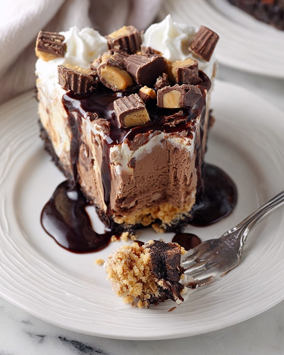 A thick slice of dessert with three visible layers sits on a white plate with a delicate swirled pattern. The bottom layer is crumbly and light brown, topped with a creamy, smooth chocolate layer in the middle. Above that is a mix of chocolate pieces and peanut butter cups embedded in a fudgy, slightly lighter brown layer. The top is decorated with small whipped cream dollops and chunks of peanut butter cups, all drizzled generously with glossy dark chocolate syrup that flows over the edges onto the plate. A fork near the dessert holds a bite showing all the layers. The scene is set on a white marbled surface. Photo taken with an iphone --ar 4:5 --v 7