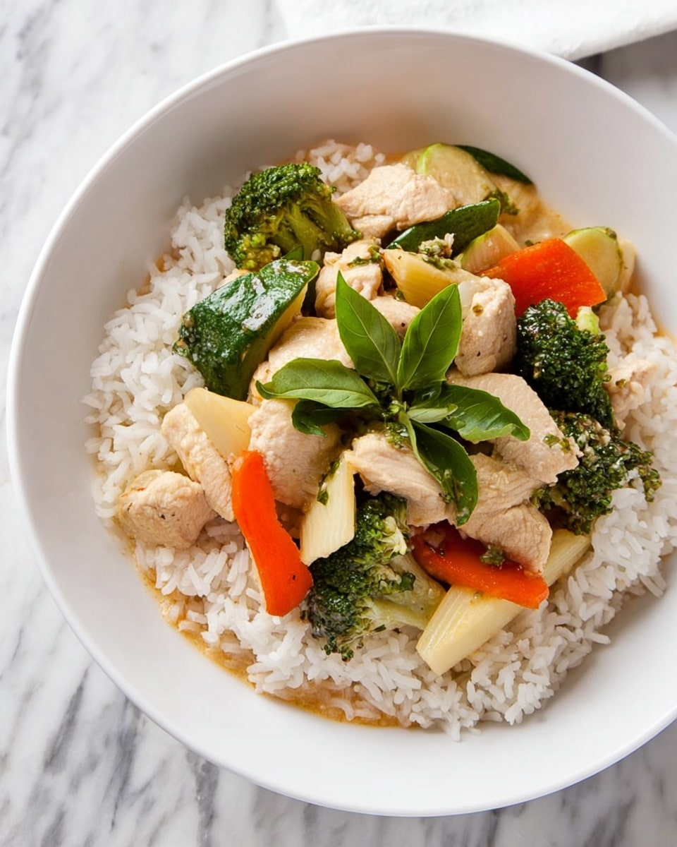 A white bowl filled with a base layer of fluffy white rice topped with a colorful mix of light beige chicken pieces, bright green broccoli florets, orange baby carrots, pale yellow bamboo shoots, and a few fresh green herb leaves in the center. The textures show tender chicken and crisp vegetables arranged naturally on the rice, with the bowl placed on a white marbled surface. photo taken with an iphone --ar 4:5 --v 7