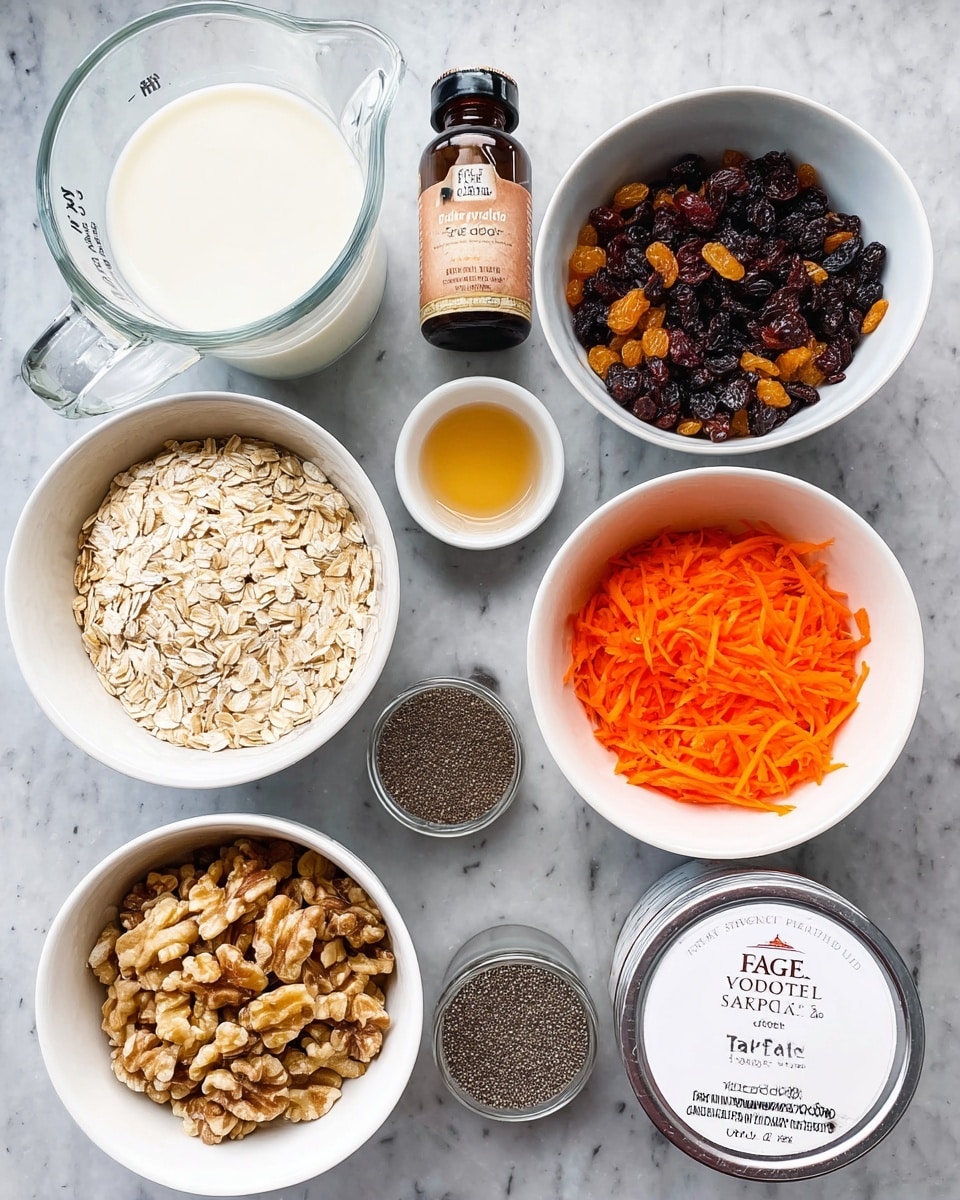 A top view of several white bowls and glass jar arranged neatly on a white marbled surface. One bowl is filled with light tan rolled oats, another contains a mix of dark brown raisins and light brown walnut pieces side by side. A third bowl holds bright orange shredded carrots, and a fourth is filled with small black chia seeds. A small white bowl contains a light golden syrup. To the side, a clear glass measuring cup is filled with white milk, and next to it, there are two small glass jars labeled cinnamon and allspice with light brown contents. A dark brown bottle labeled Madagascar vanilla bean paste is also present. In the center, a container with a foil lid marked