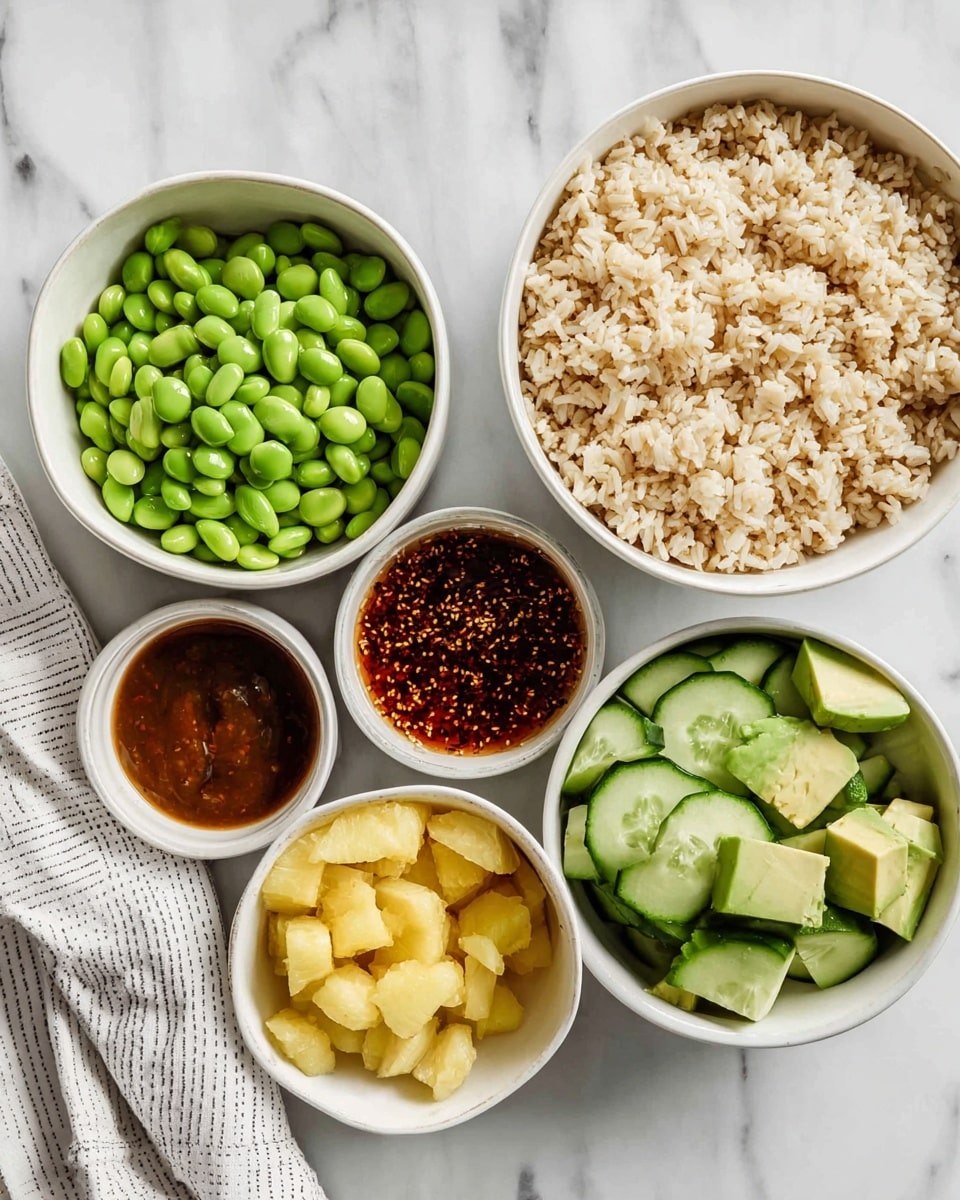 The image shows six white bowls arranged on a white marbled surface. The largest bowl on the far right is filled with cooked rice, light beige in color and fluffy in texture. To the left of it is a bowl filled with bright green edamame beans, smooth and shiny. Above this is a bowl of sliced cucumber rounds, dark green on the edges with a lighter green center, giving a fresh and crisp look. Next to the cucumbers is a small bowl with a dark reddish-brown sauce that has visible seeds and a thick consistency. Below this is a small bowl with yellow pineapple chunks, unevenly shaped but juicy in appearance. Finally, to the right of the pineapple is a bowl holding green avocado pieces that are cut into a grid pattern and look creamy. The bowls are neatly spaced with a white and gray striped cloth in the upper left corner. photo taken with an iphone --ar 4:5 --v 7