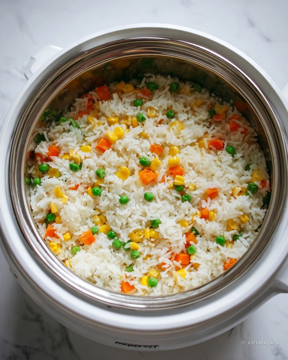 A white bowl filled with one layer of cooked white rice mixed with small pieces of orange carrots, yellow corn kernels, and green peas evenly spread throughout. The rice grains look soft and fluffy, and the vegetables add a bright, colorful contrast. The bowl sits on a white marbled surface, creating a clean and simple background. photo taken with an iphone --ar 4:5 --v 7